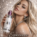 Glamorous blonde model holds a perfume bottle against a glittery backdrop; 'Experience' tagline below.